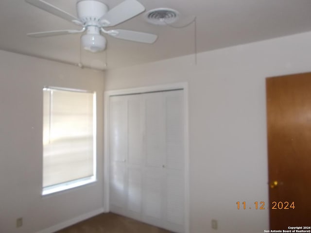 unfurnished bedroom with a closet, visible vents, and a ceiling fan