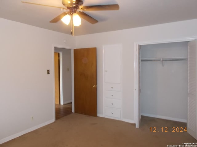 unfurnished bedroom with a ceiling fan, carpet, baseboards, and a closet