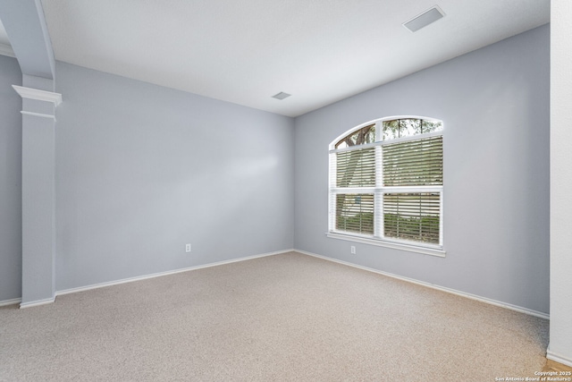 unfurnished room with light carpet, visible vents, and baseboards