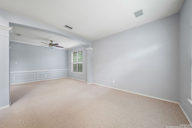 spare room featuring light carpet, visible vents, and a ceiling fan