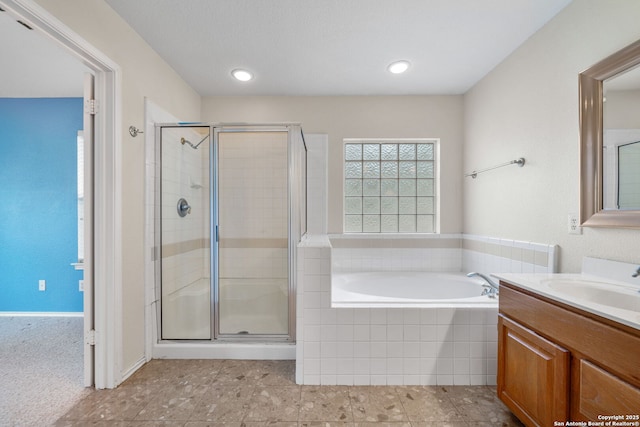 bathroom featuring a stall shower, vanity, and a bath