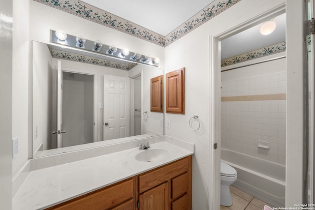 bathroom with toilet, shower / washtub combination, vanity, and tile patterned floors