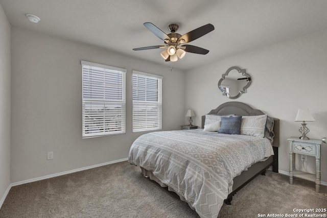 carpeted bedroom featuring a ceiling fan and baseboards