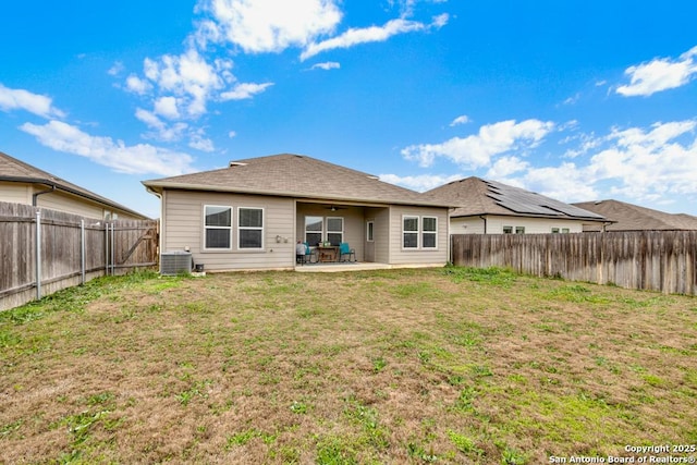 back of house featuring cooling unit, a fenced backyard, a patio, and a lawn