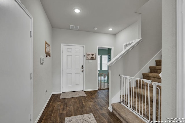 entryway featuring baseboards, visible vents, dark wood-style floors, stairway, and recessed lighting