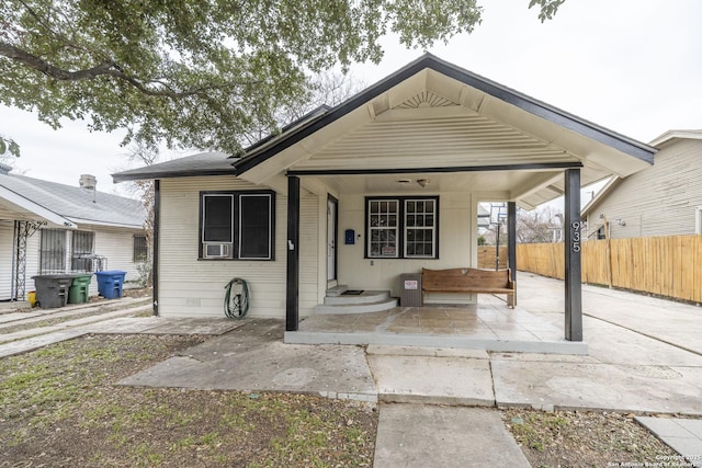 bungalow-style home with a patio area and fence