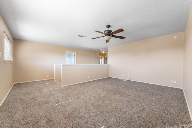 spare room with visible vents, baseboards, ceiling fan, carpet, and a textured ceiling