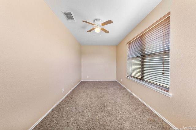 empty room featuring a ceiling fan, carpet flooring, visible vents, and baseboards