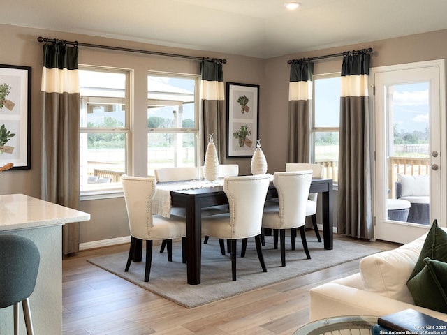 dining room featuring recessed lighting, light wood-type flooring, and baseboards