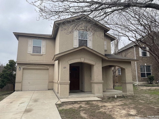 traditional-style home with an attached garage, driveway, and stucco siding