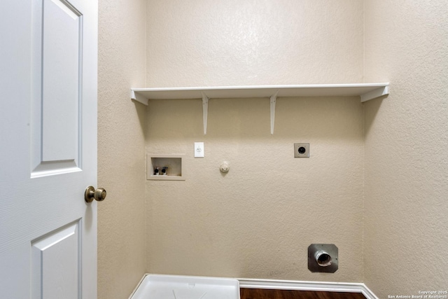 laundry area featuring a textured wall, gas dryer hookup, hookup for a washing machine, hookup for an electric dryer, and laundry area