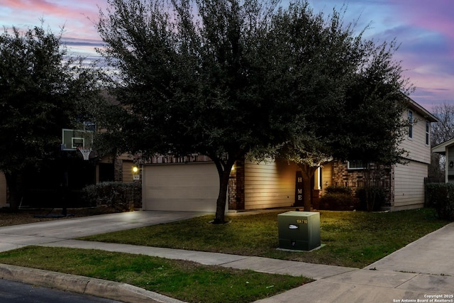 obstructed view of property featuring a front lawn, driveway, and an attached garage