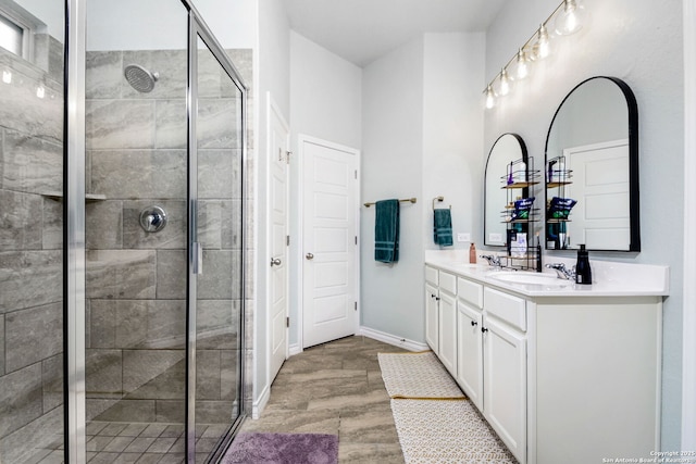 13818 Cessna, San Antonio, TX 78245 - bathroom featuring double vanity, tiled shower, a sink, and baseboards