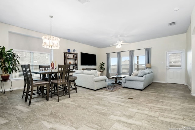 13818 Cessna, San Antonio, TX 78245 - living room featuring baseboards, visible vents, and ceiling fan with notable chandelier