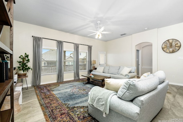 13818 Cessna, San Antonio, TX 78245 - living area with arched walkways, visible vents, ceiling fan, light wood-type flooring, and baseboards