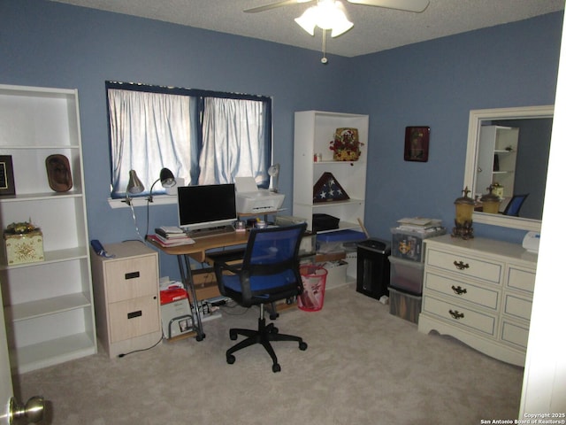 office area with light carpet, ceiling fan, and a textured ceiling