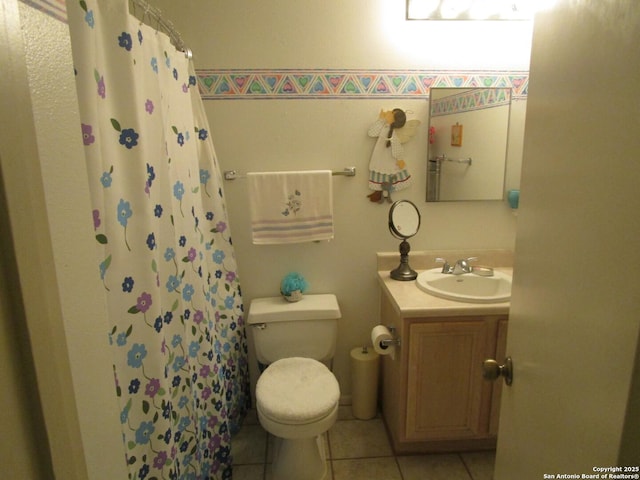 bathroom featuring toilet, a shower with curtain, tile patterned flooring, and vanity