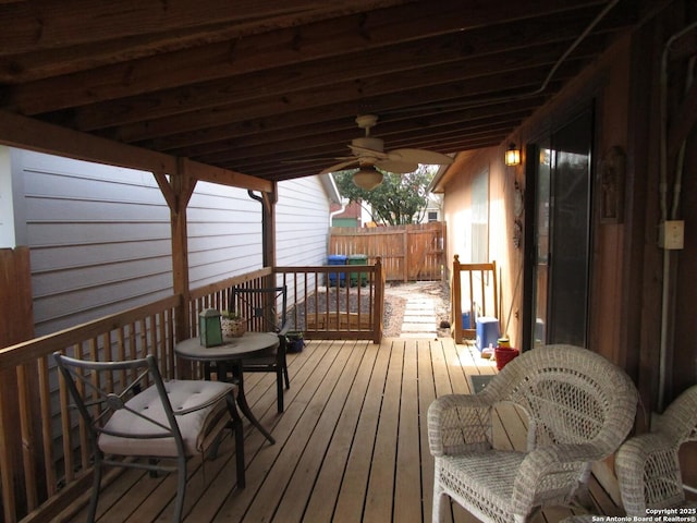 wooden deck featuring ceiling fan and fence