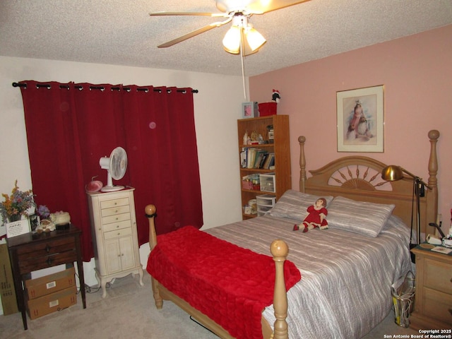 carpeted bedroom with ceiling fan and a textured ceiling