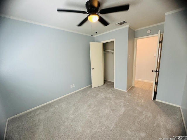 unfurnished bedroom with baseboards, visible vents, crown molding, and light colored carpet