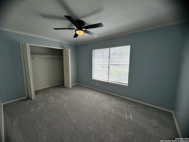 unfurnished bedroom featuring a textured ceiling, baseboards, a closet, carpet, and crown molding