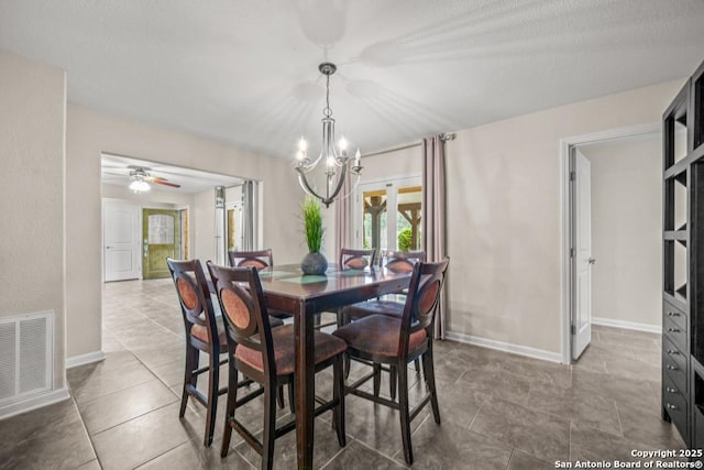 tiled dining space with a chandelier, visible vents, and baseboards