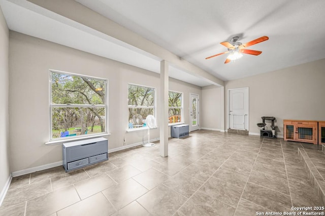 interior space featuring ceiling fan, tile patterned floors, and baseboards