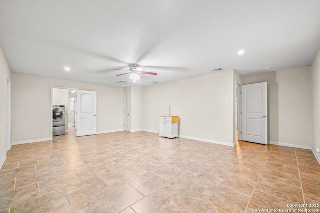 unfurnished living room with ceiling fan, recessed lighting, visible vents, baseboards, and washer / clothes dryer