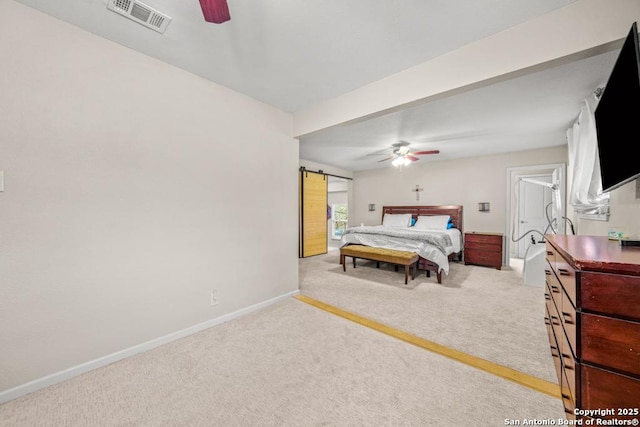 bedroom with light carpet, a barn door, visible vents, baseboards, and ceiling fan