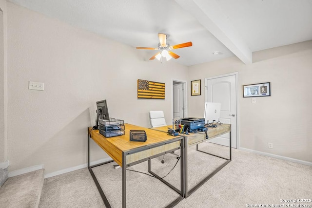 office area with light carpet, baseboards, beam ceiling, and a ceiling fan