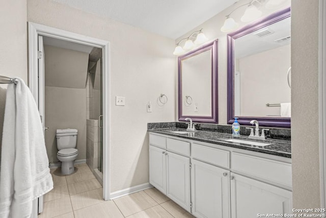 full bath featuring double vanity, a shower with door, baseboards, and a sink