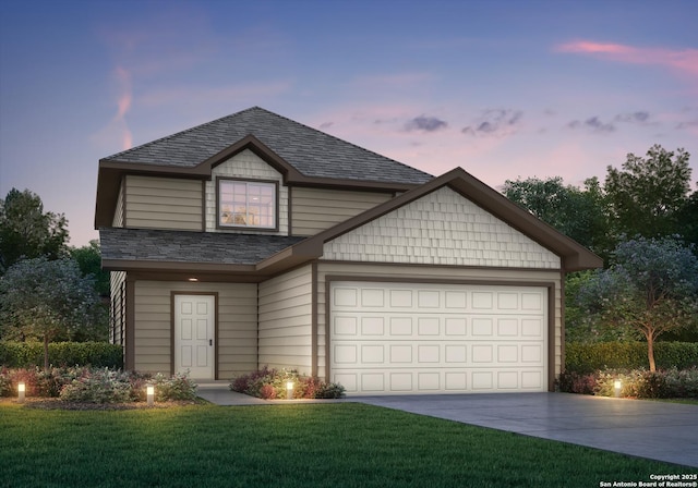 view of front facade featuring a garage, concrete driveway, a yard, and roof with shingles