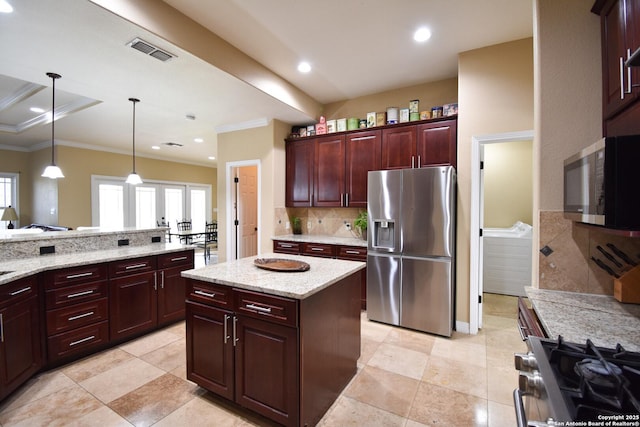 kitchen with a kitchen island, hanging light fixtures, ornamental molding, appliances with stainless steel finishes, and tasteful backsplash