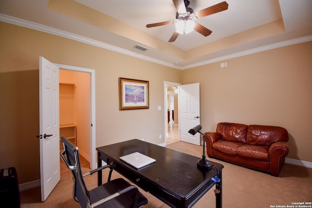 home office featuring ceiling fan, light carpet, a raised ceiling, and visible vents