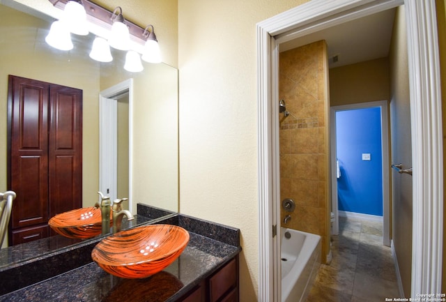 bathroom featuring visible vents, tub / shower combination, tile patterned flooring, and vanity