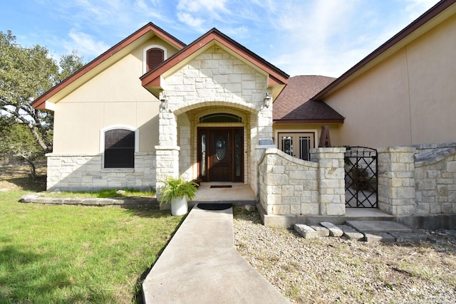 view of front of home with stone siding, a front lawn, roof with shingles, and stucco siding