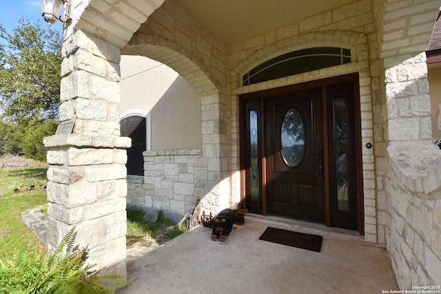 doorway to property featuring stone siding