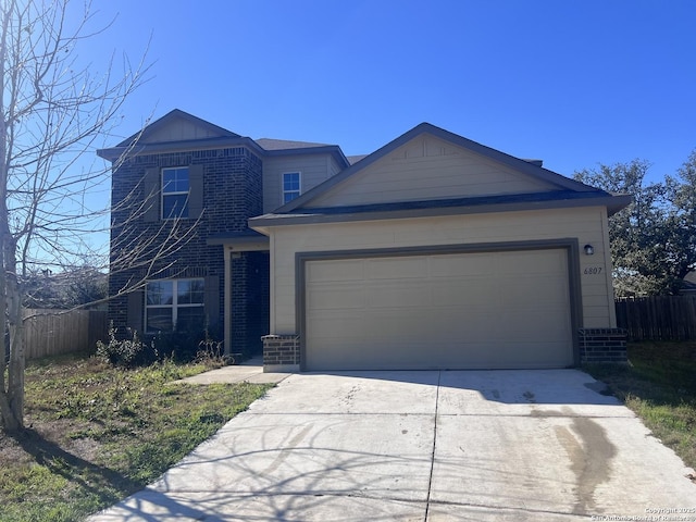 view of front of property with a garage, driveway, fence, and brick siding