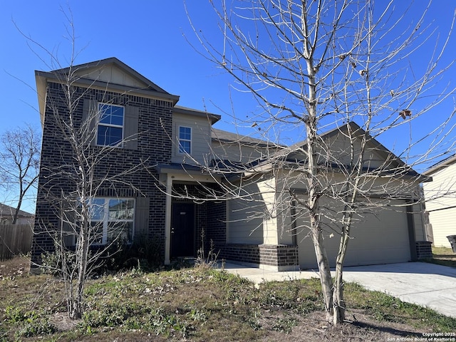 traditional home with an attached garage, concrete driveway, and brick siding