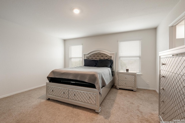 bedroom with light carpet and baseboards