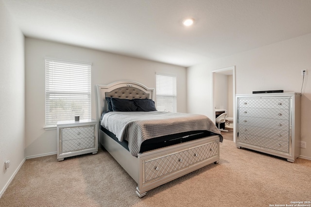 bedroom featuring baseboards and light colored carpet