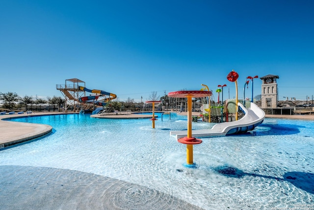 view of swimming pool with a water play area and a water slide