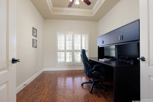 office area with a ceiling fan, wood finished floors, baseboards, a tray ceiling, and crown molding