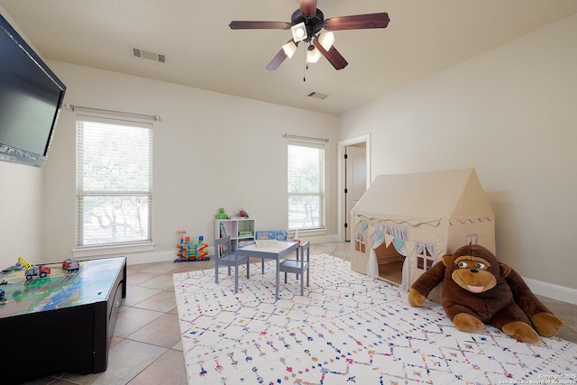 game room with light tile patterned floors, a healthy amount of sunlight, visible vents, and baseboards