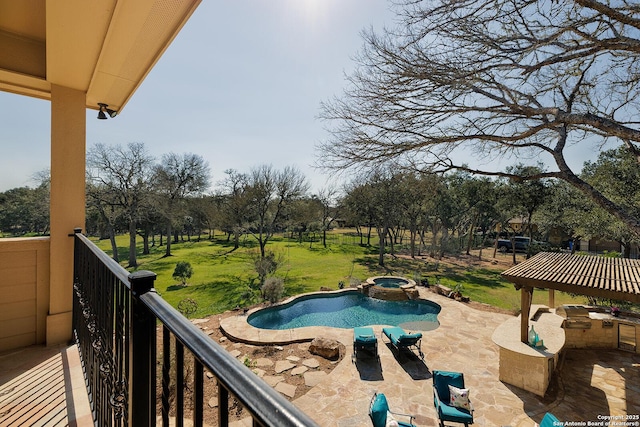 view of pool with a yard and a pool with connected hot tub