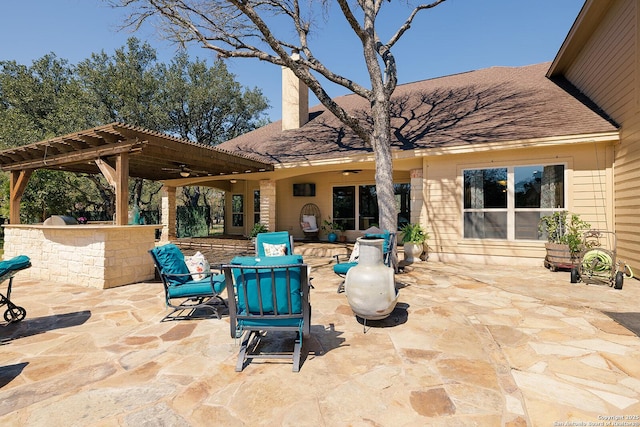 view of patio / terrace featuring a pergola and exterior kitchen