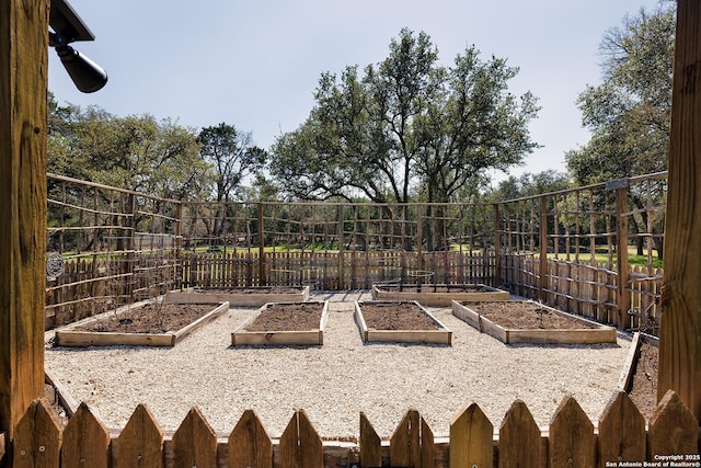 view of yard featuring fence and a garden