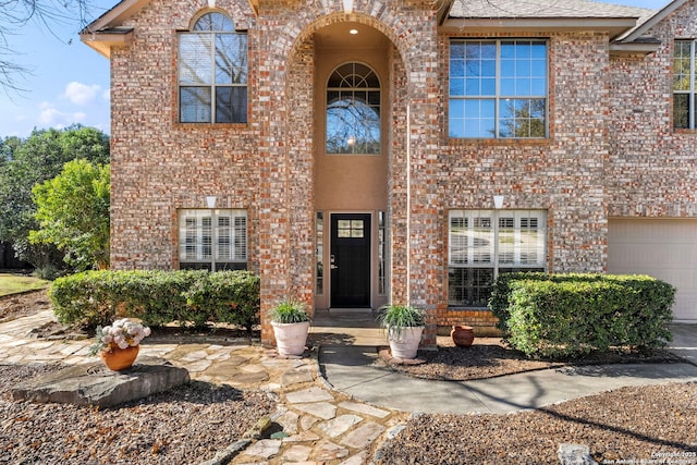 view of front of home featuring brick siding and an attached garage