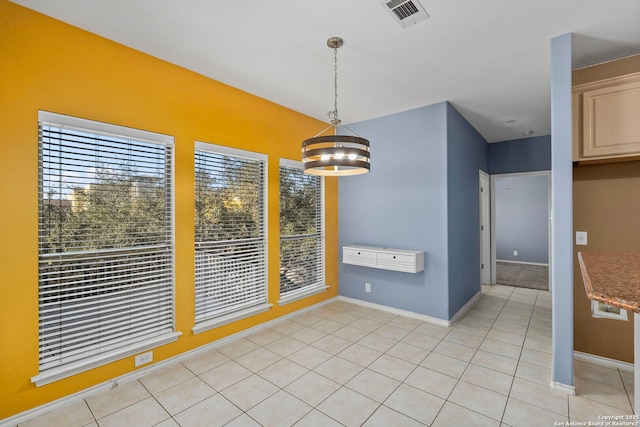 unfurnished dining area featuring visible vents, baseboards, and light tile patterned flooring