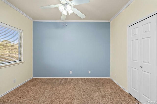 unfurnished bedroom featuring ornamental molding, carpet flooring, and baseboards